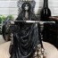 black holy grim reaper sitting on
