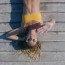 woman sunbathing on wooden jetty drone