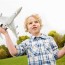 boy looking up at airplane stock photos