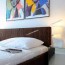 modern bedroom with pop art above the