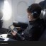 boy sitting in plane and playing video