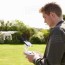 man flying drone quadcopter in garden