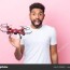 young brazilian man holding drone