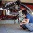 repairman cheking engine in small