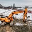 a powerful excavator digs the earth in