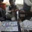 afghan currency dip exposes aid