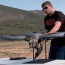 a handgun attached drone trackimo