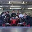 team working on race car in garage