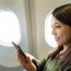 woman using cellphone inside airplane