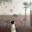 artist paints fantastical wall murals