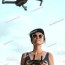 woman flying drone under sky with